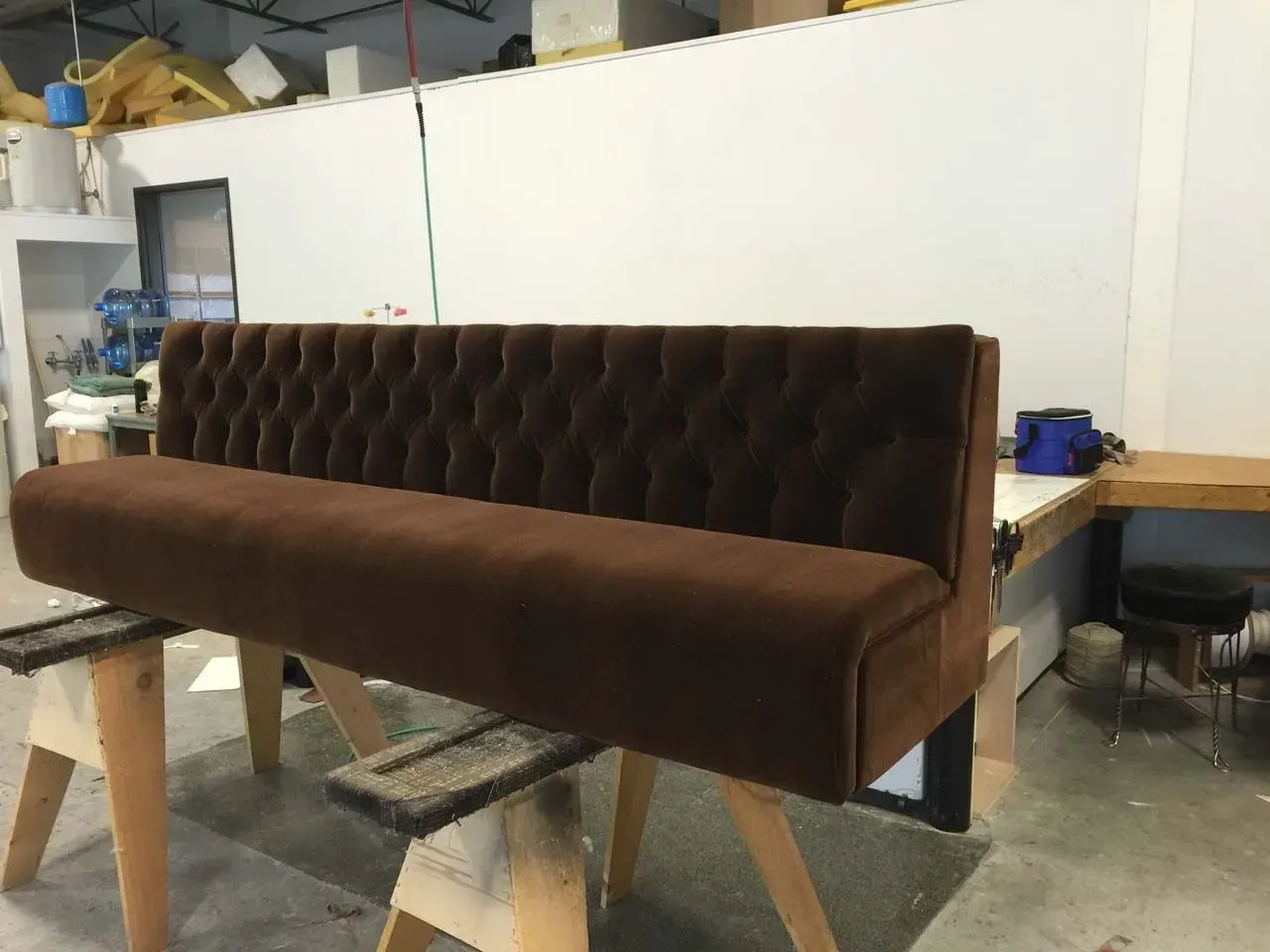 A brown couch is sitting on a wooden table