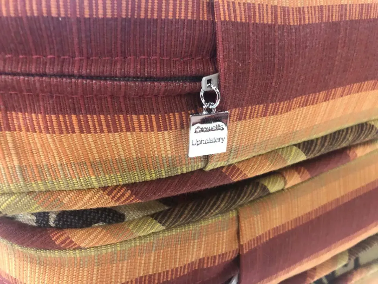 A close up of a stack of cushions with a zipper.