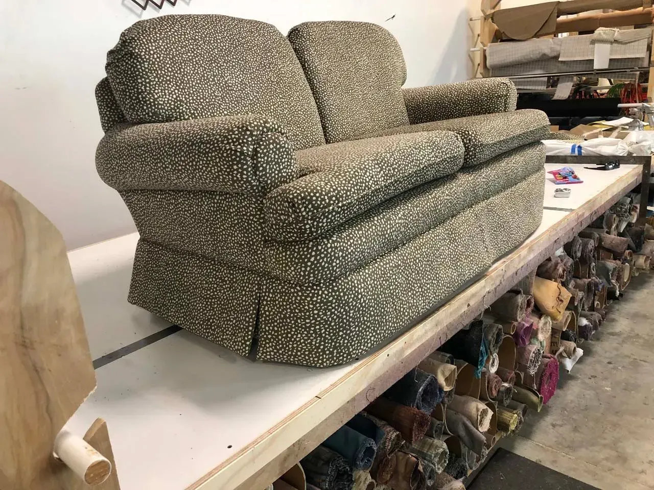 A couch is sitting on top of a table in a room.