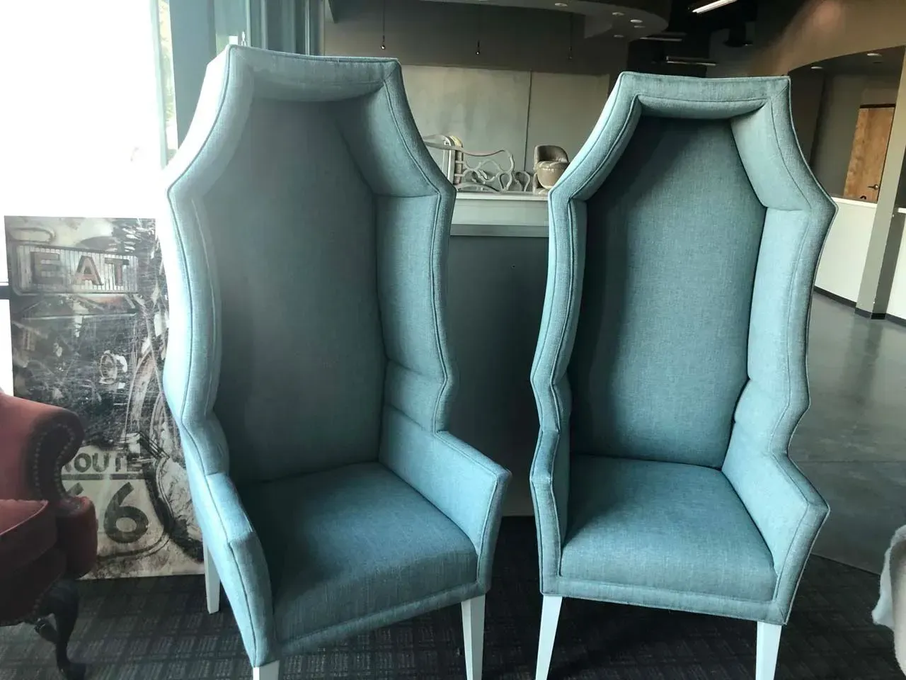 Two chairs are sitting next to each other in front of a sign that says route 66