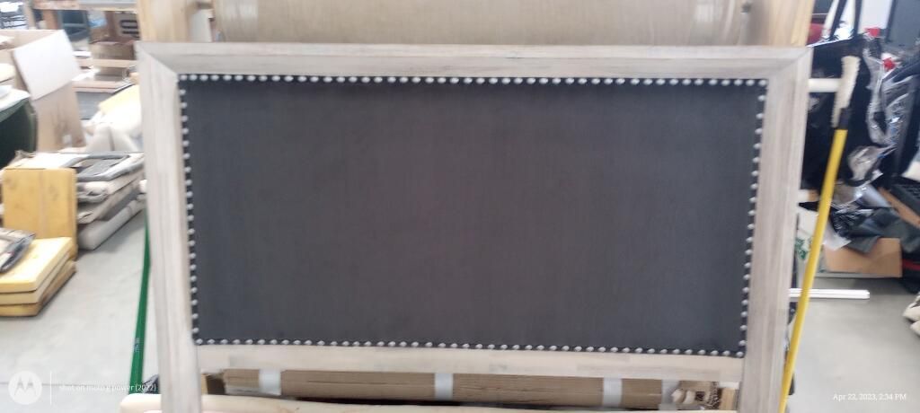 A chalkboard is sitting on a table in a warehouse.