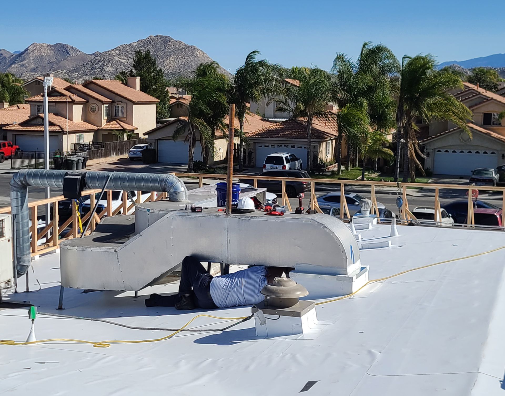 A man is working on the roof of a building