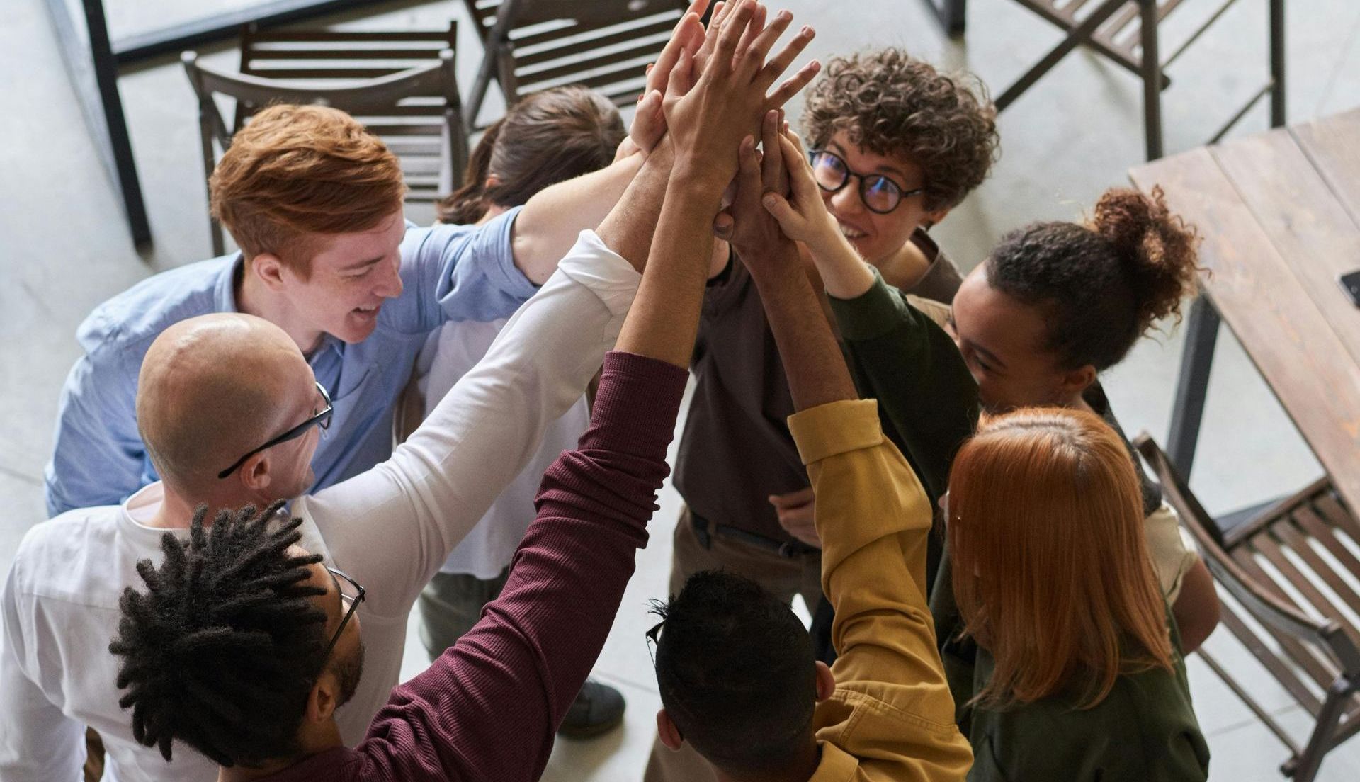 A group of people are giving each other a high five.