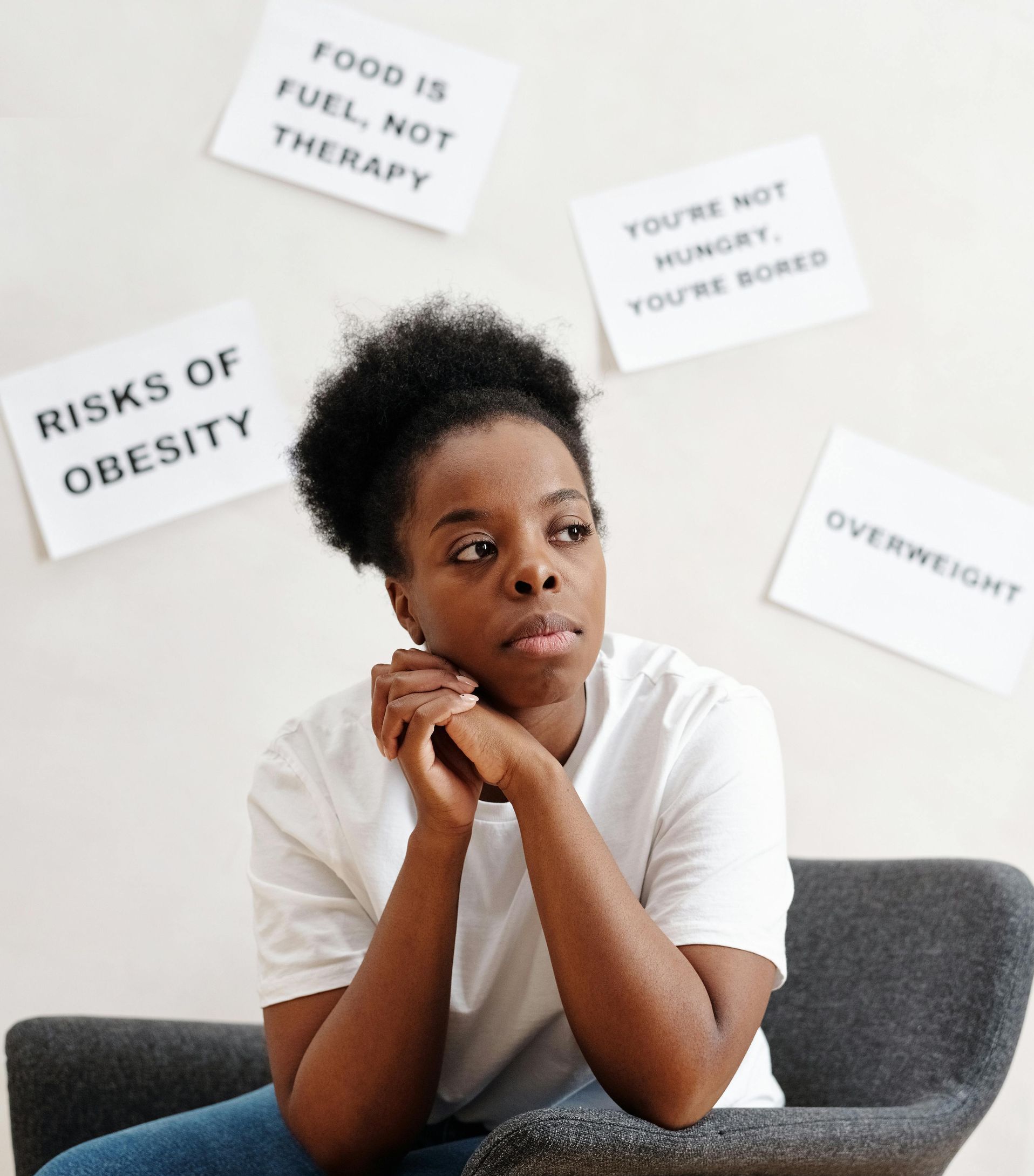 A woman is sitting in a chair concrned about her hormone health.