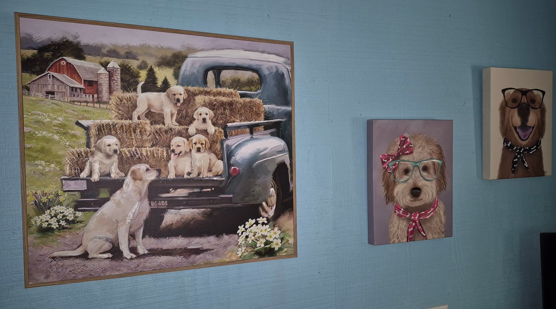 There are three paintings of dogs on the wall.