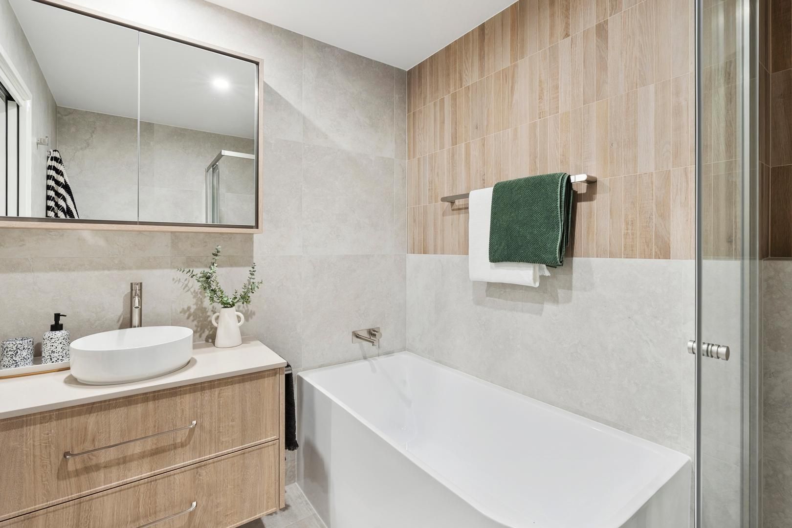 A bathroom with two sinks and a bathtub