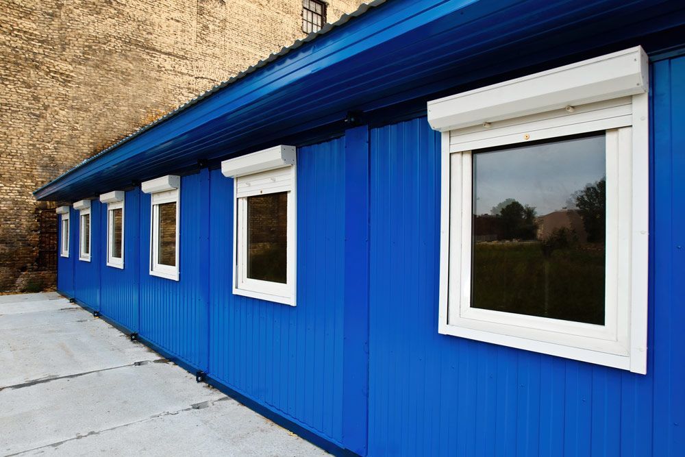 Long Construction Building Next To Brick Wall Painting — Professional Painters in Brunswick Heads, NSW