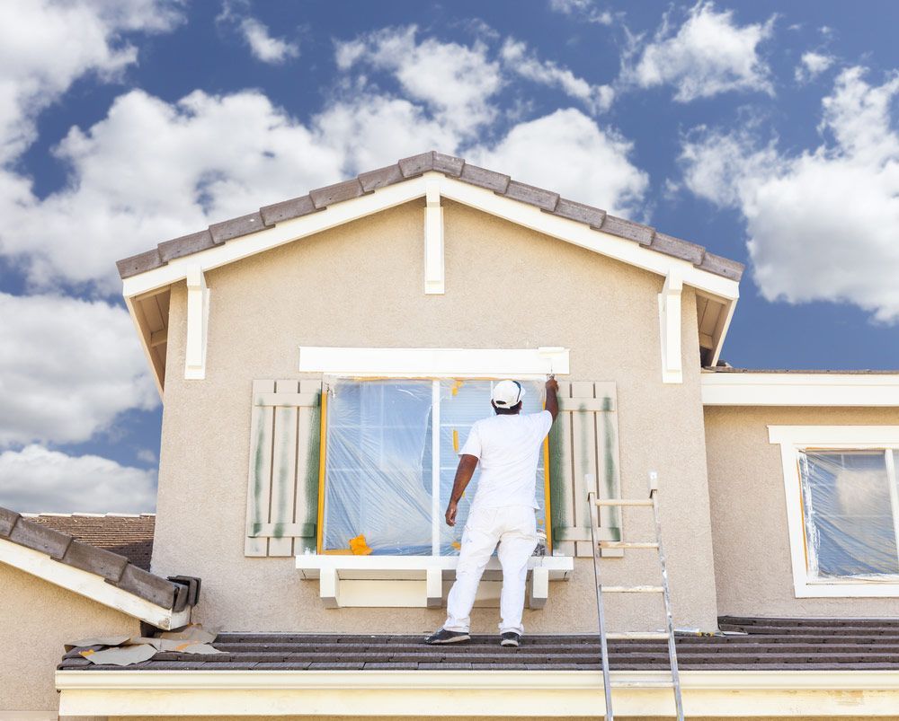 Busy House Painter Painting The Trim And Shutters Of A Home — House Painter in Suffolk Park, NSW