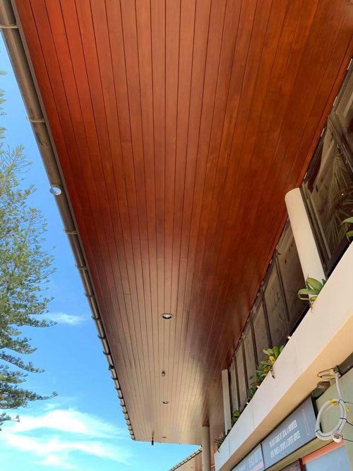 The Ceiling Of A Building With Wood Panelling And A Blue Sky — Professional Painters in Suffolk Park, NSW