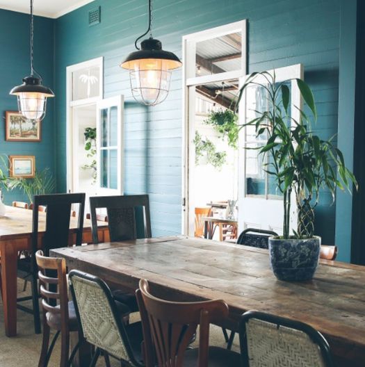 A Dining Room With Tables And Chairs And A Potted Plant On The Table — Professional Painters in Suffolk Park, NSW