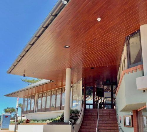 A Building With A Wooden Ceiling And Stairs Leading Up To It — Professional Painters in Suffolk Park, NSW