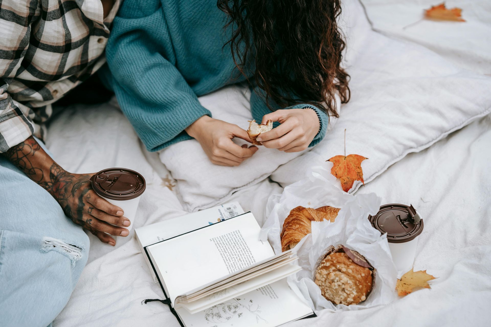 Couple journaling at their bed during fall season.