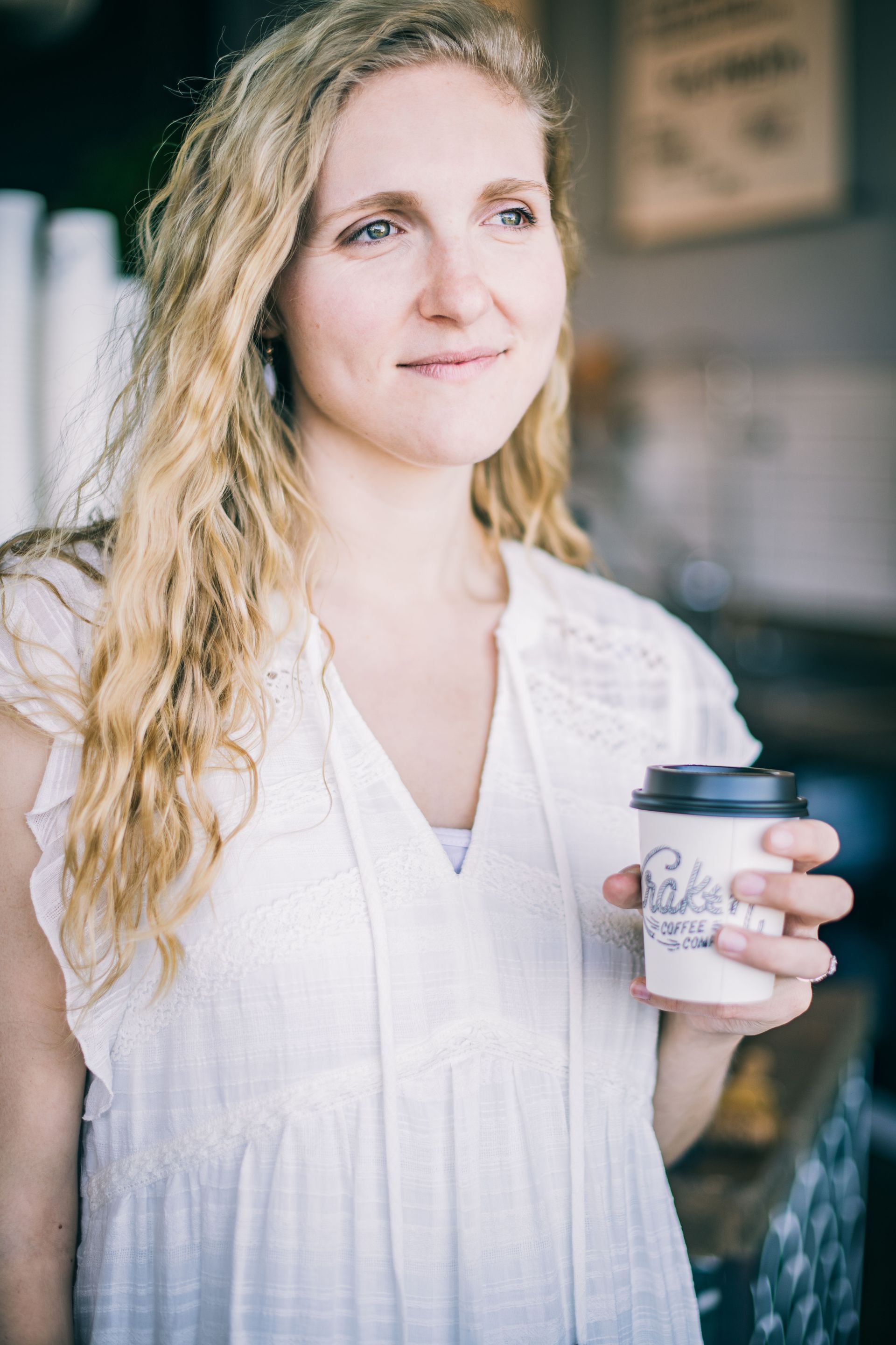 Woman with a coffee cup thinking about buying her first home in Denver metro