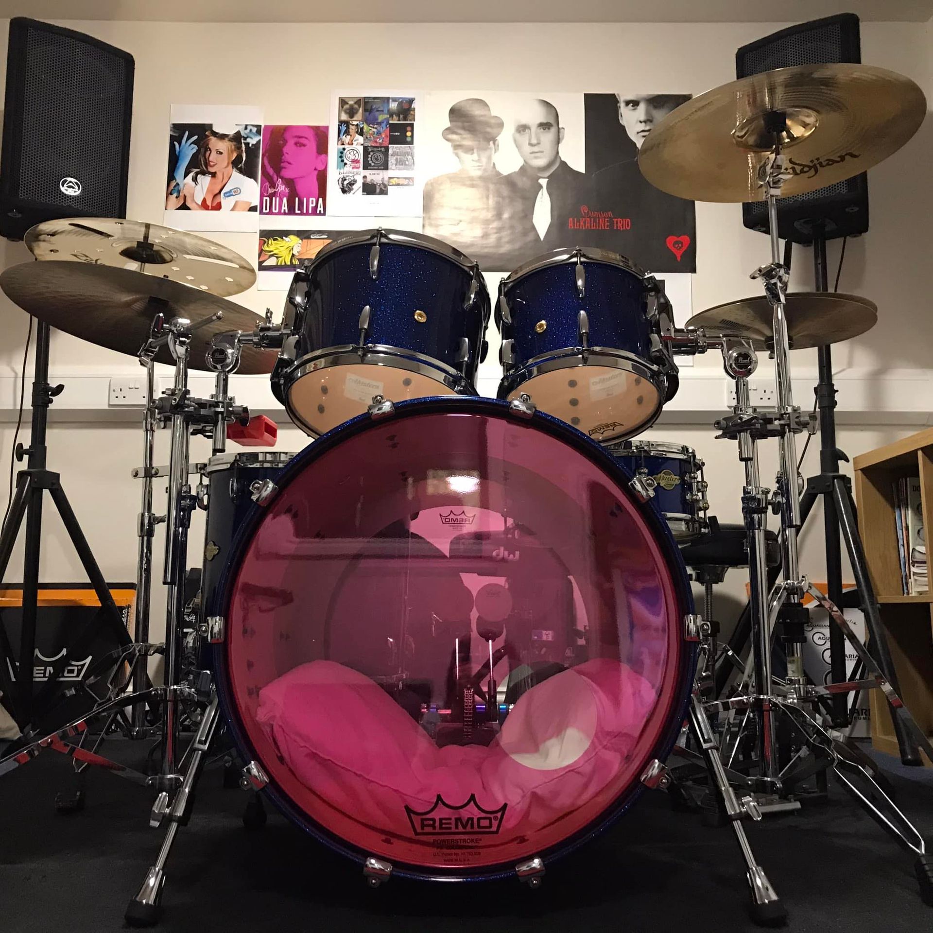 A drum set with a pink remo drum head