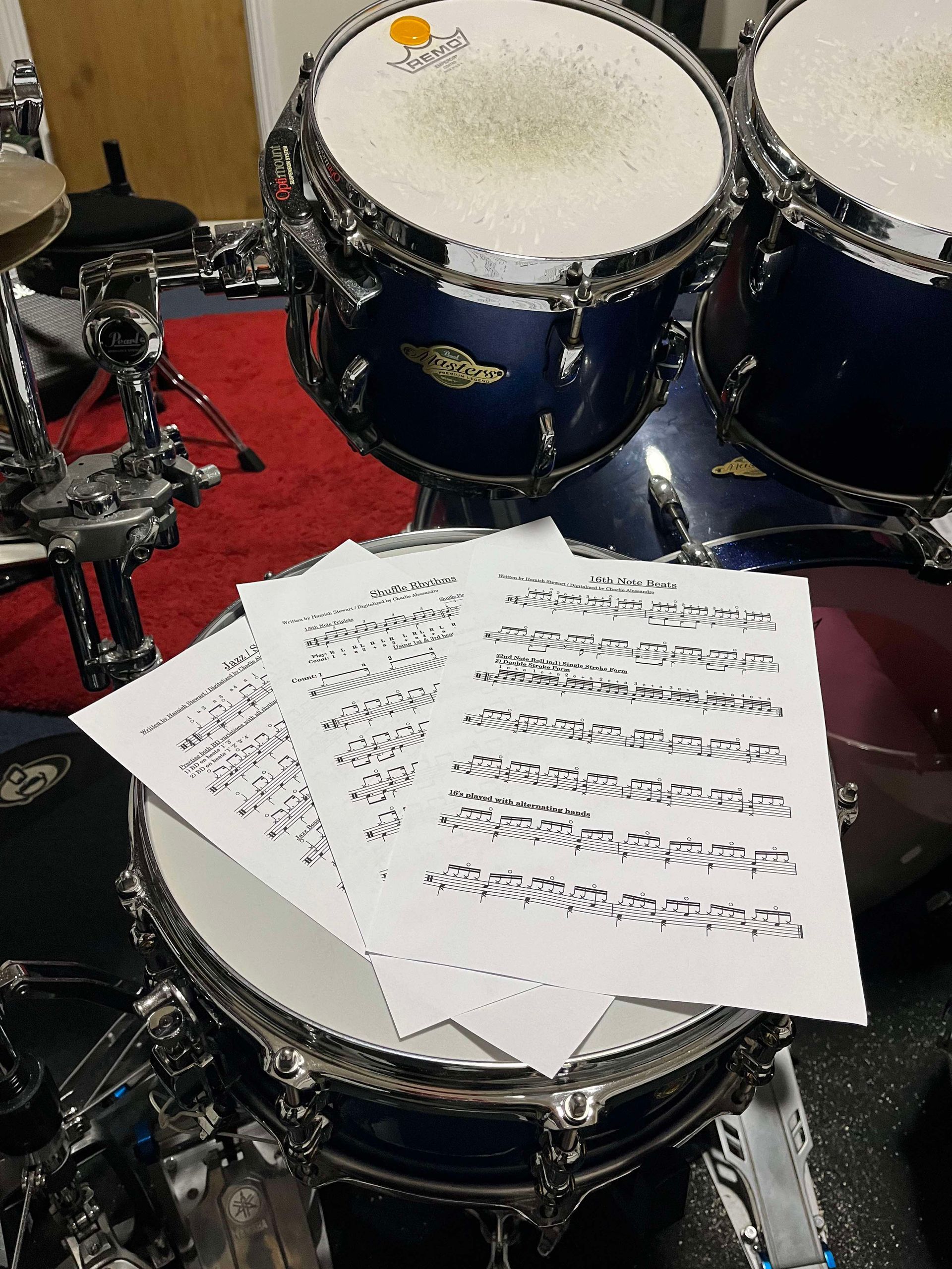 A drum set with sheet music on top of it