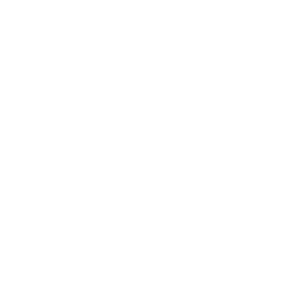 A black and white photograph of an industrial crane bridge structure viewed from below against a bright, clear sky.