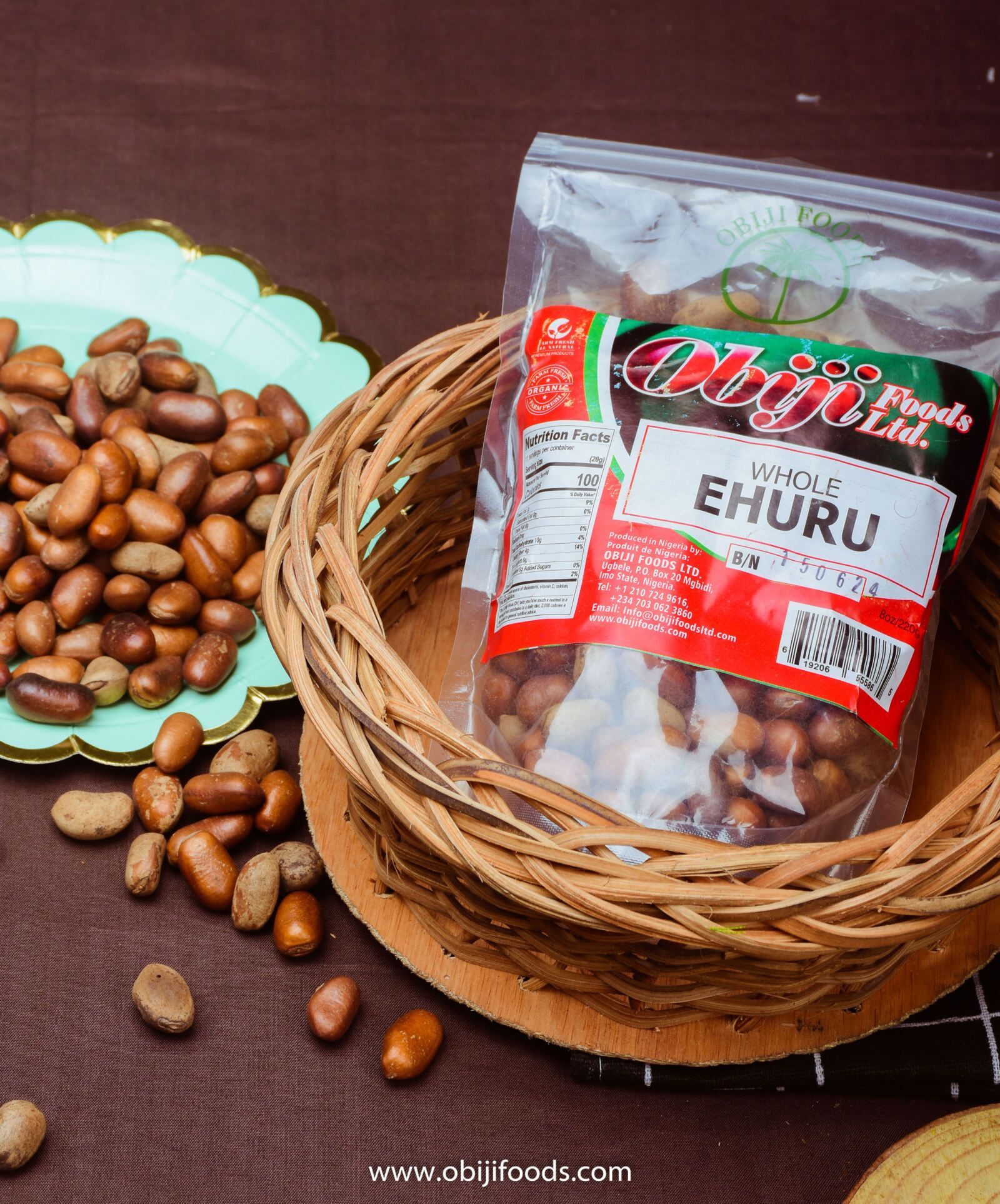 A bag of ehuru beans is sitting on top of a wicker basket.