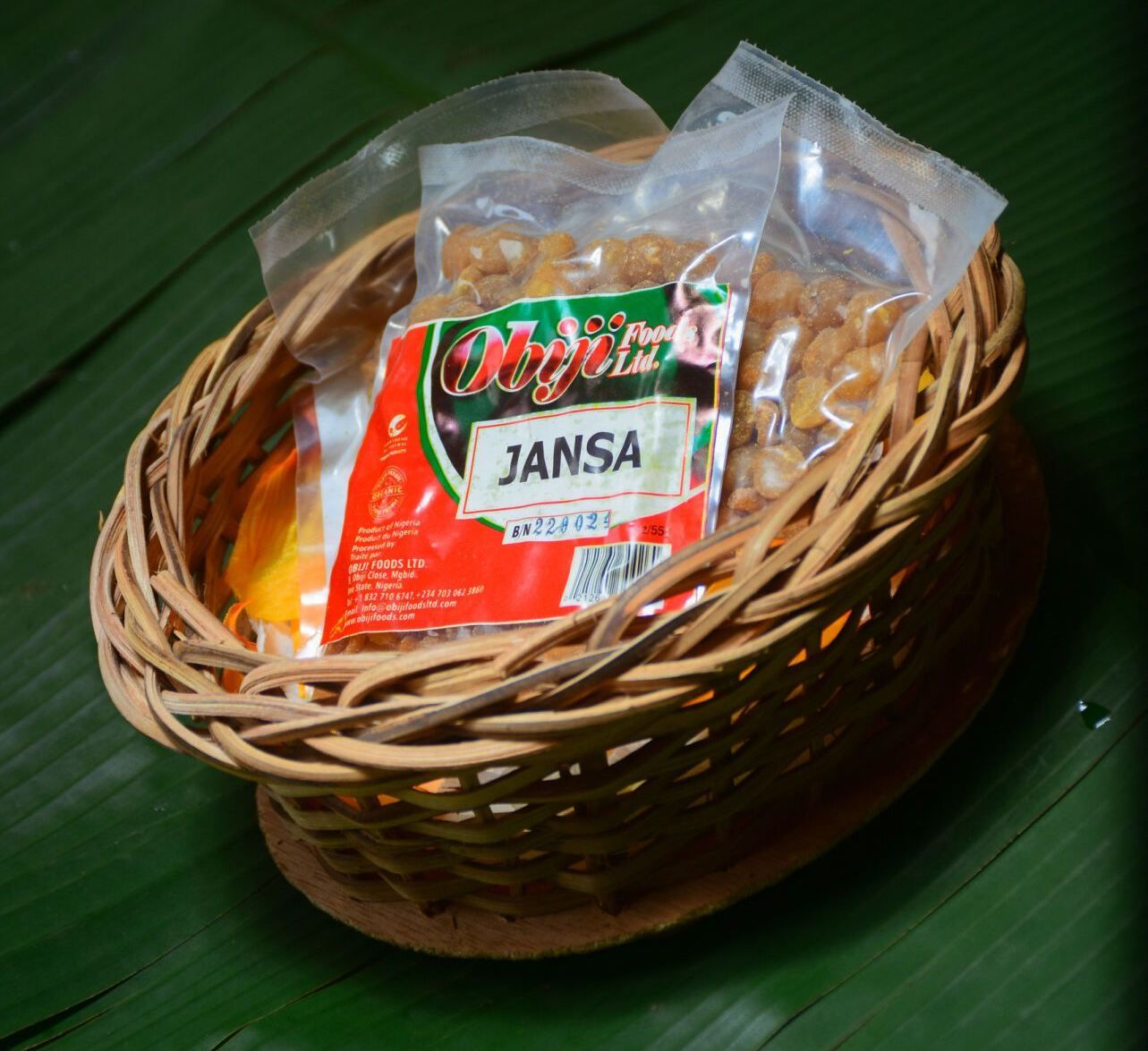 A wicker basket filled with a bag of janssa