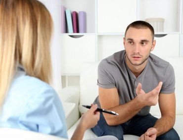 A nurse talking to a man