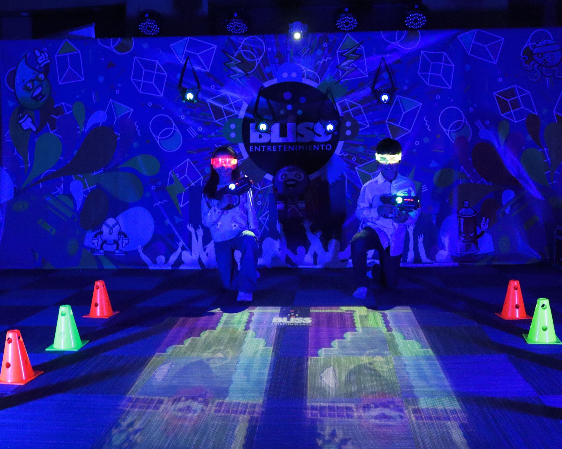 Un grupo de personas está de pie frente a una pared que brilla en la oscuridad.