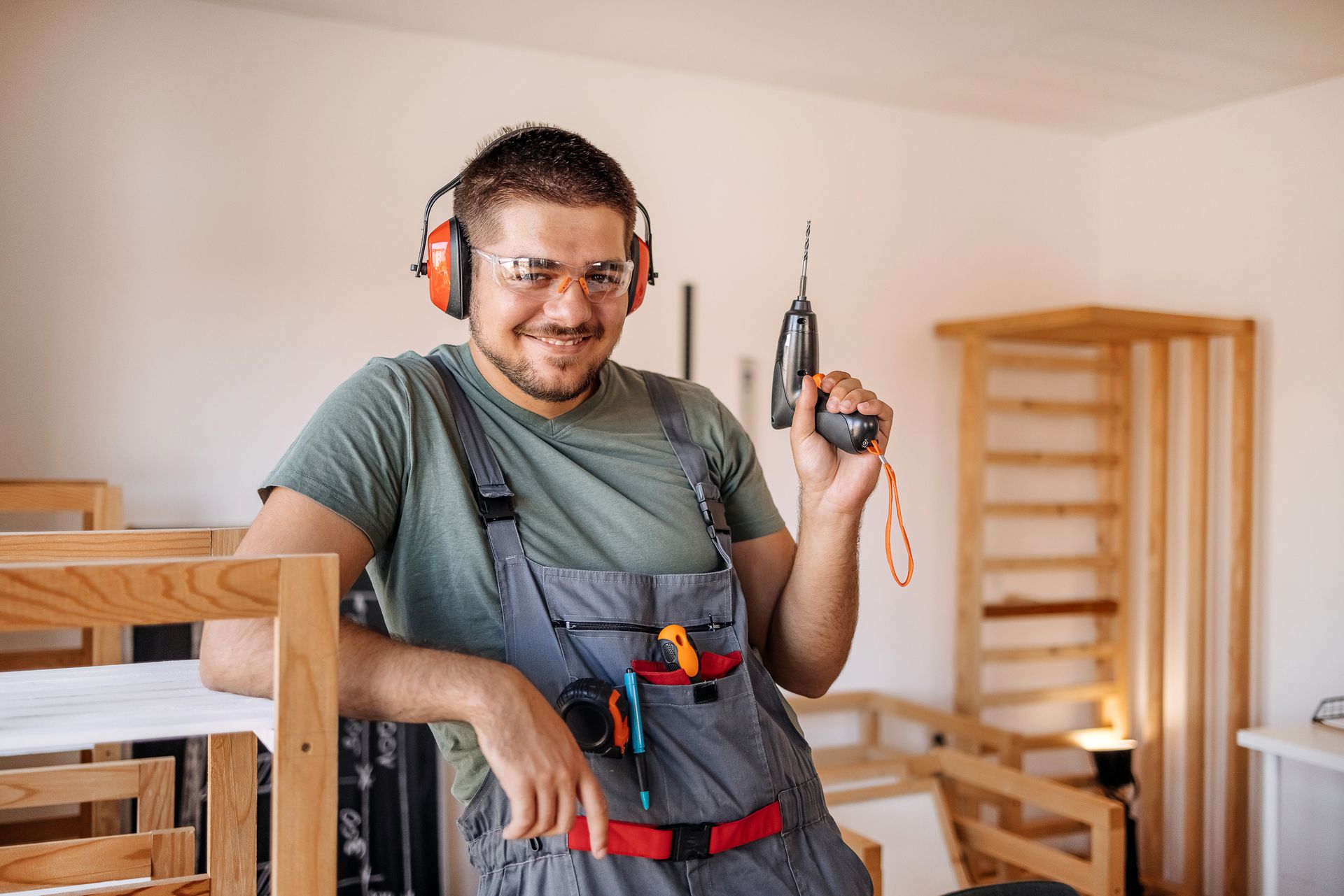 man making things out of wood in his small home carpentry workshop. man making things out of wood in his small home carpentry workshop.