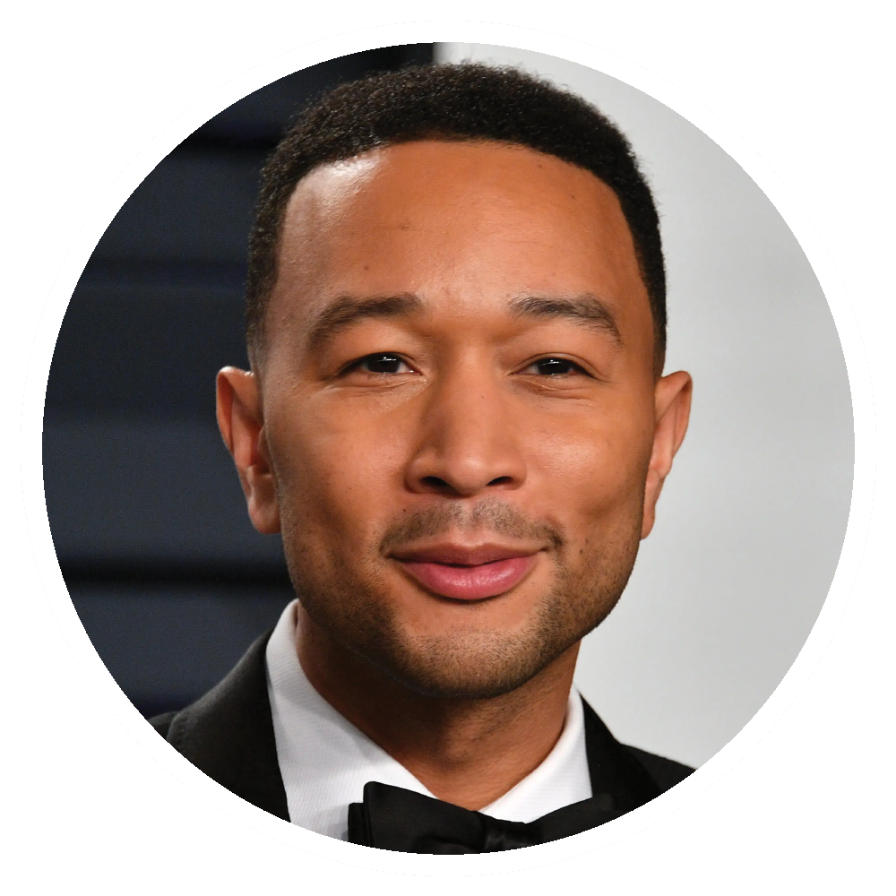 John Legend smiling, wearing a black tuxedo.