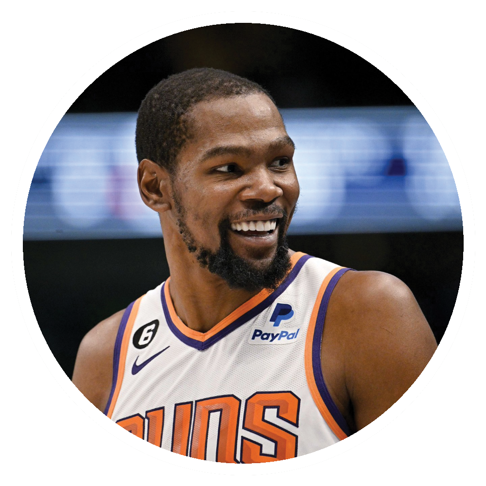 Basketball player Kevin Durant smiling, wearing a Phoenix Suns jersey.