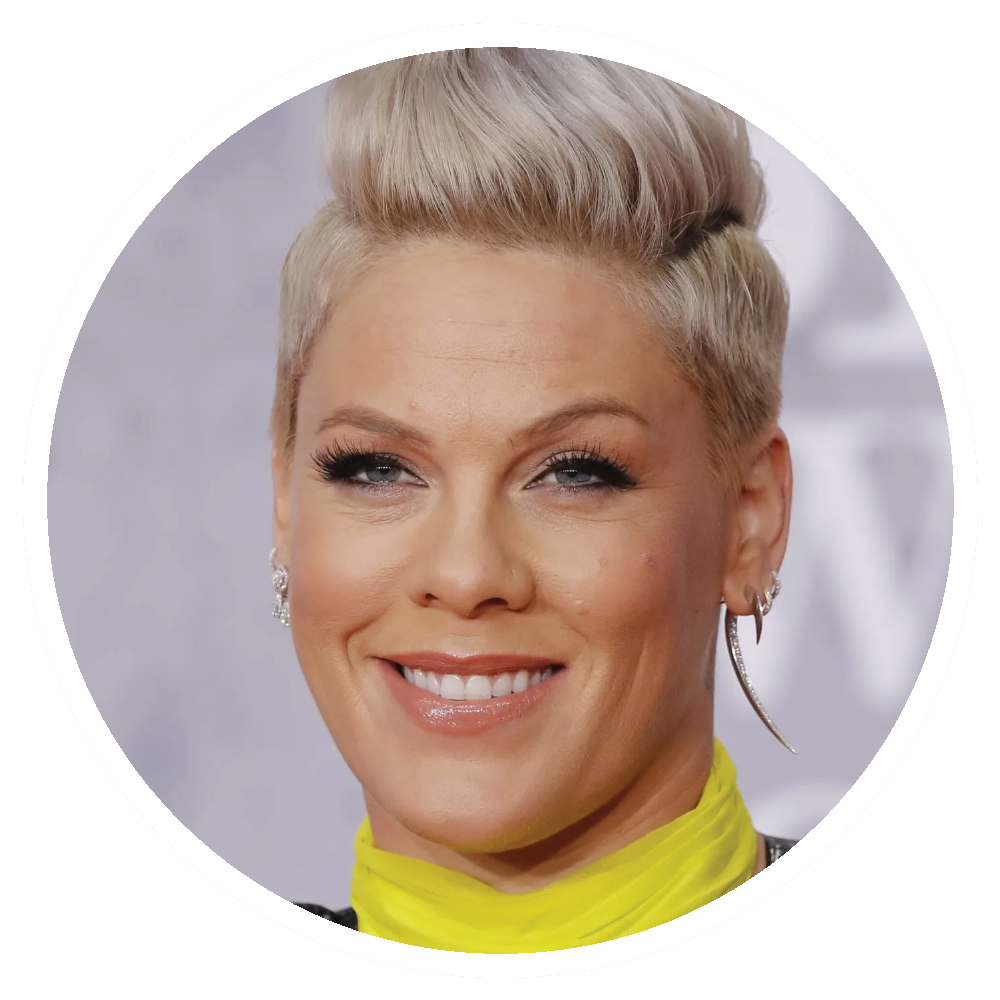 Pink with short blonde hair and a yellow collar smiles.