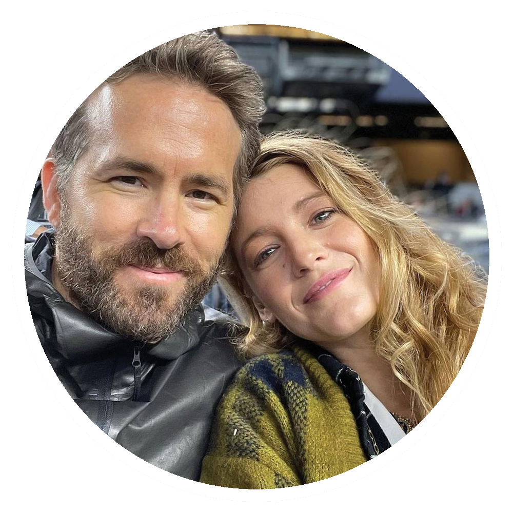 Ryan Reynolds and Blake Lively smiling and embracing in a candid shot.