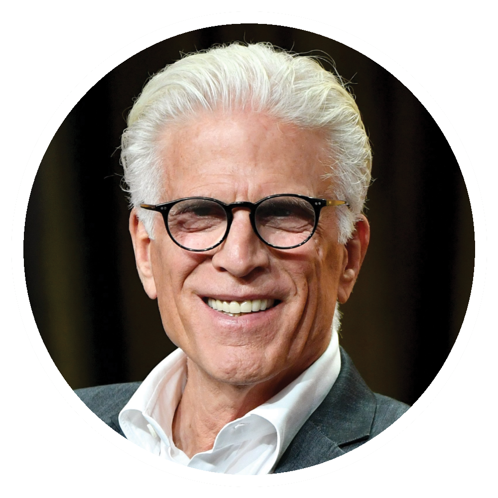 Ted Danson smiling, wearing glasses and a suit jacket.