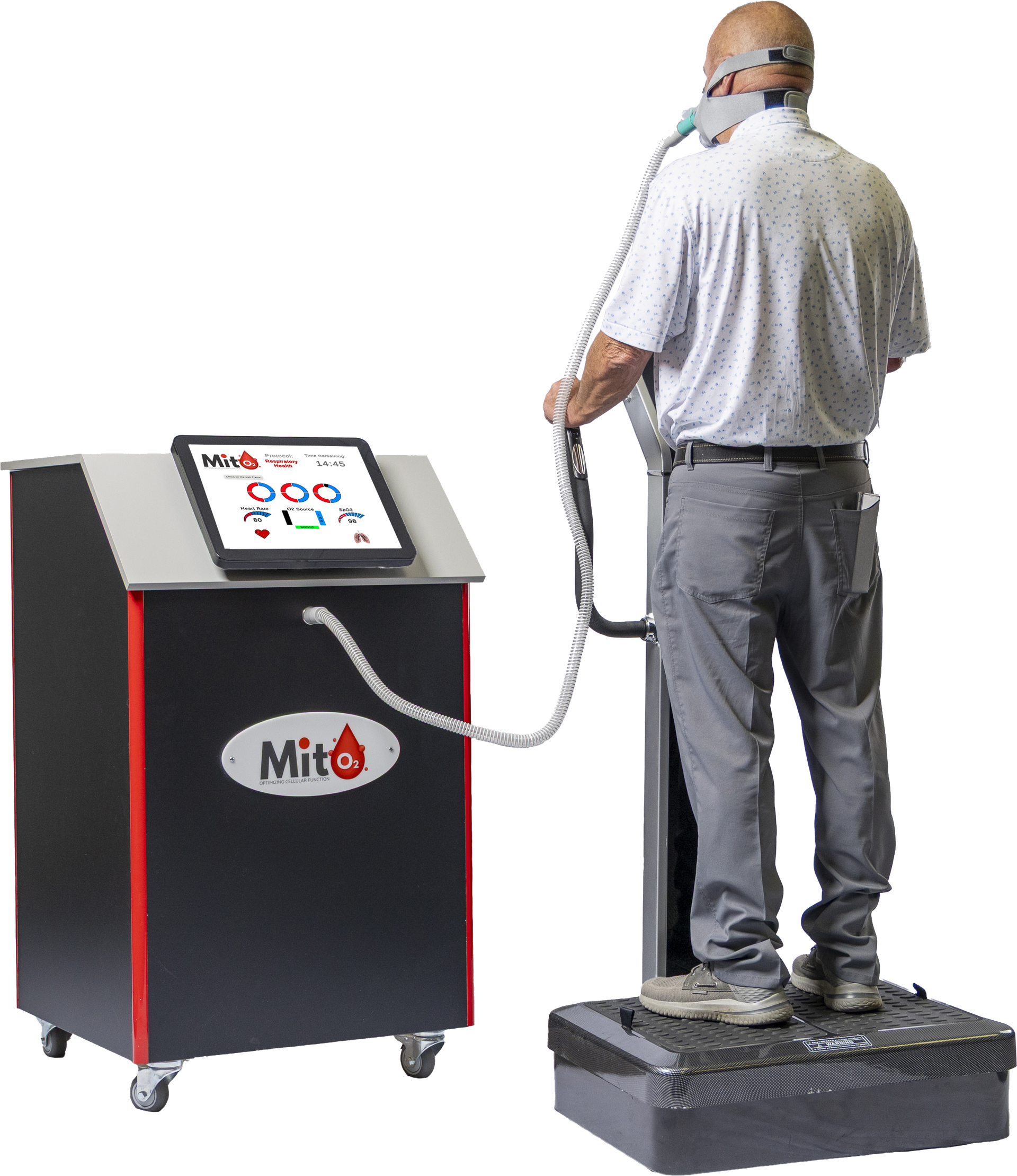 A man is standing next to a machine that is connected to a computer.