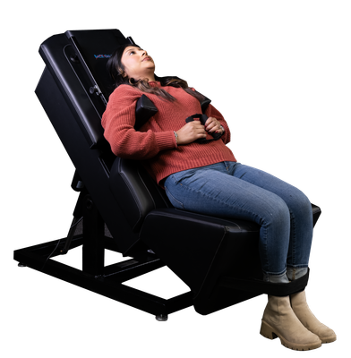 Woman in a seated inversion chair, looking upward. Black chair and frame.