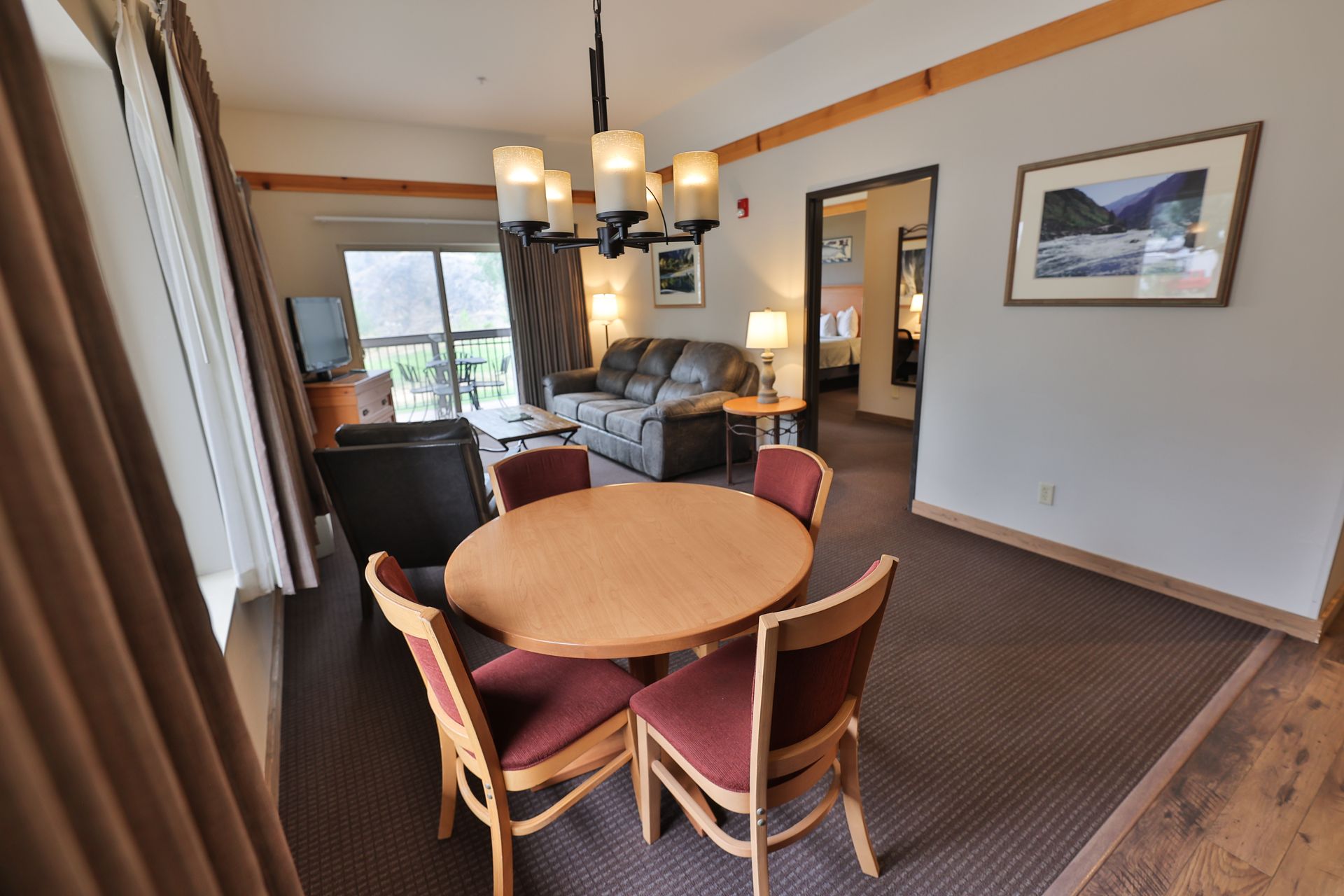A hotel room with a round table and chairs