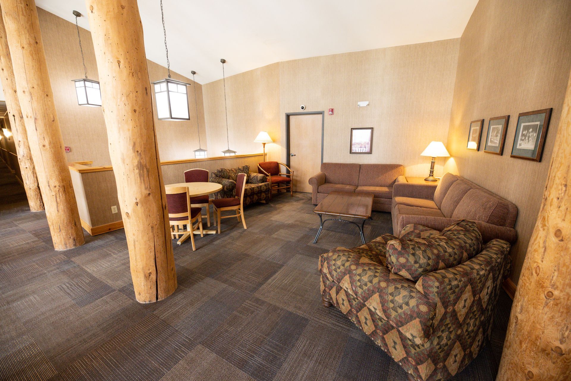 A living room with a couch , chairs , tables and lamps