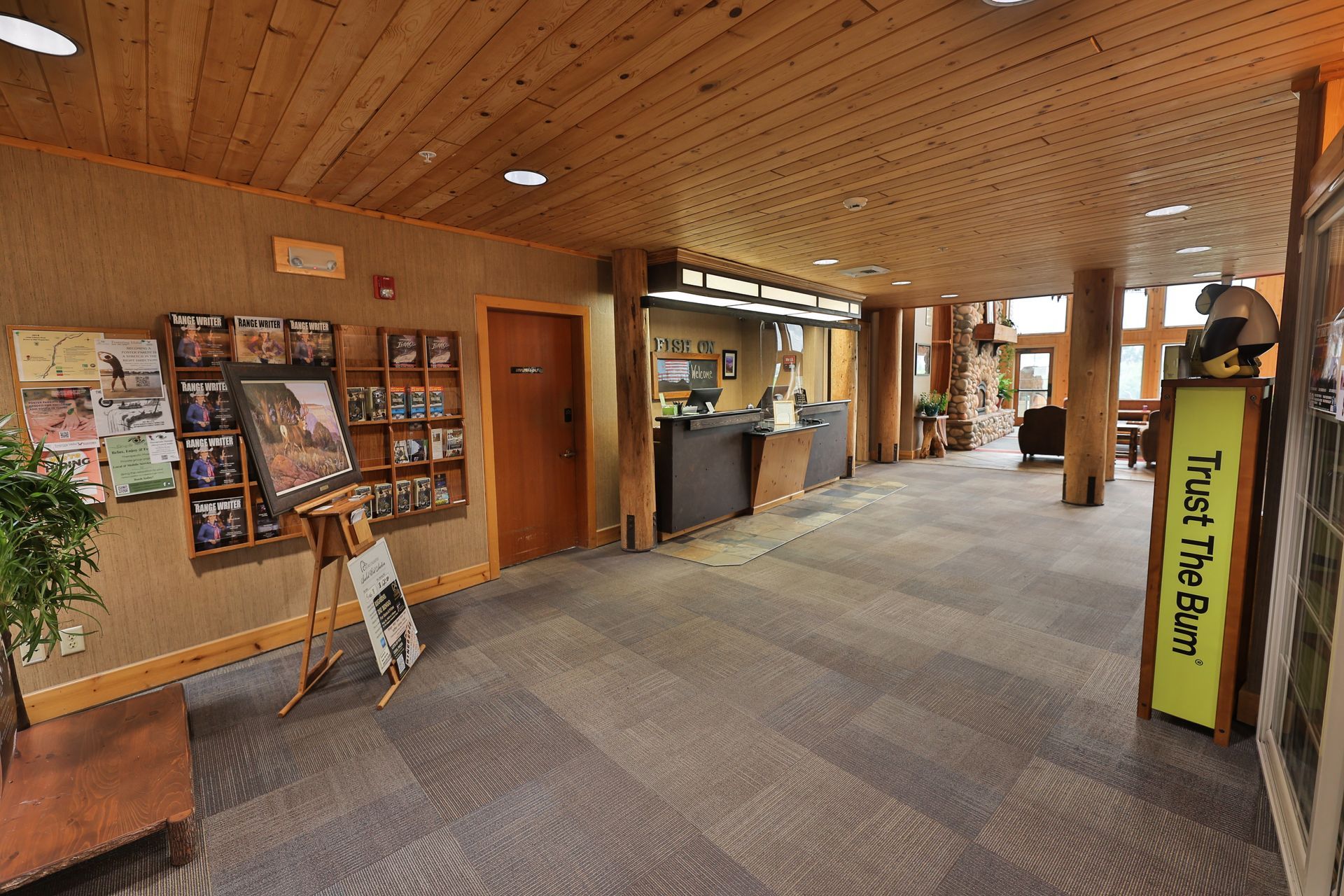 A lobby with a yellow sign that says trust the sun