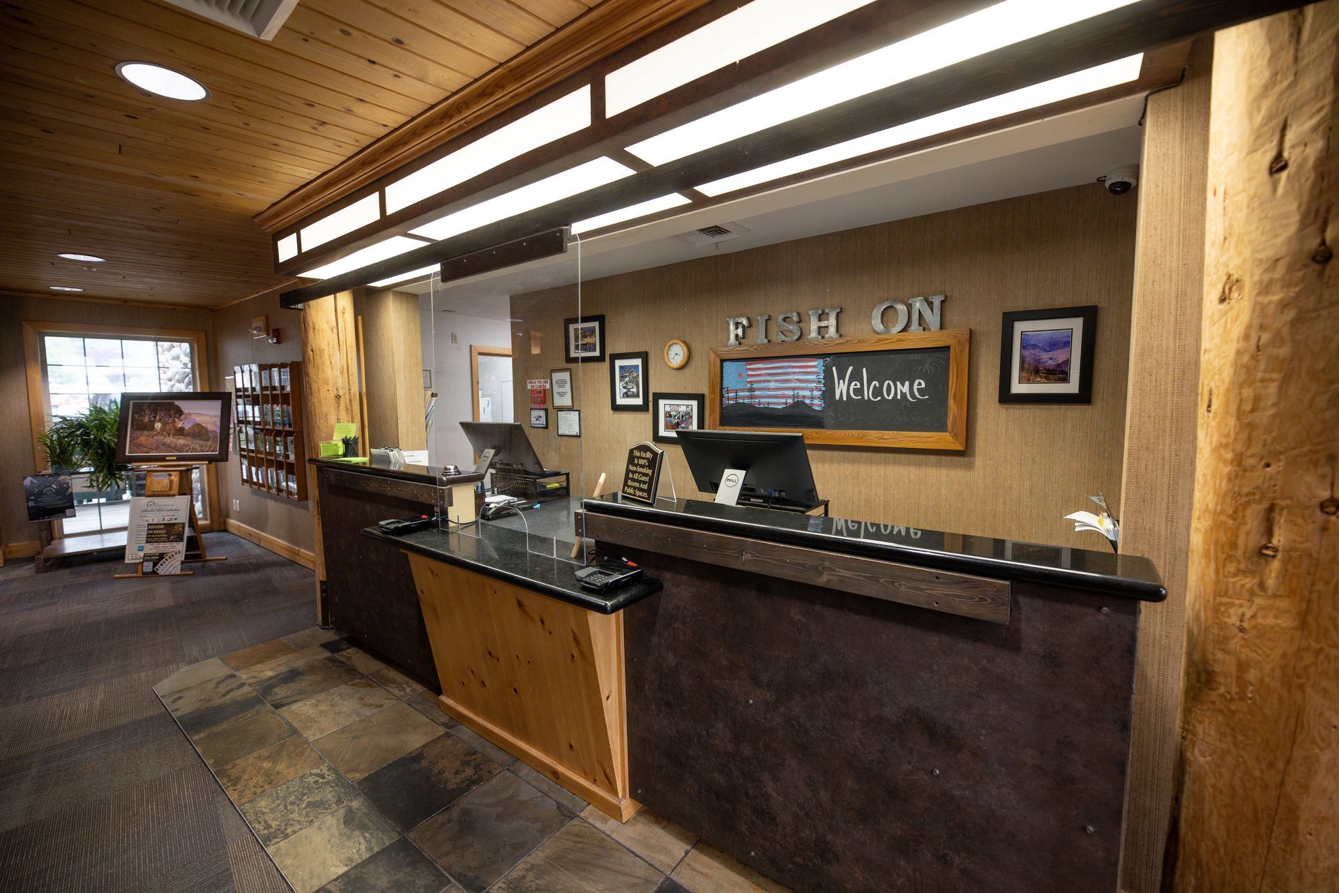 A hotel lobby with a reception desk and a computer.