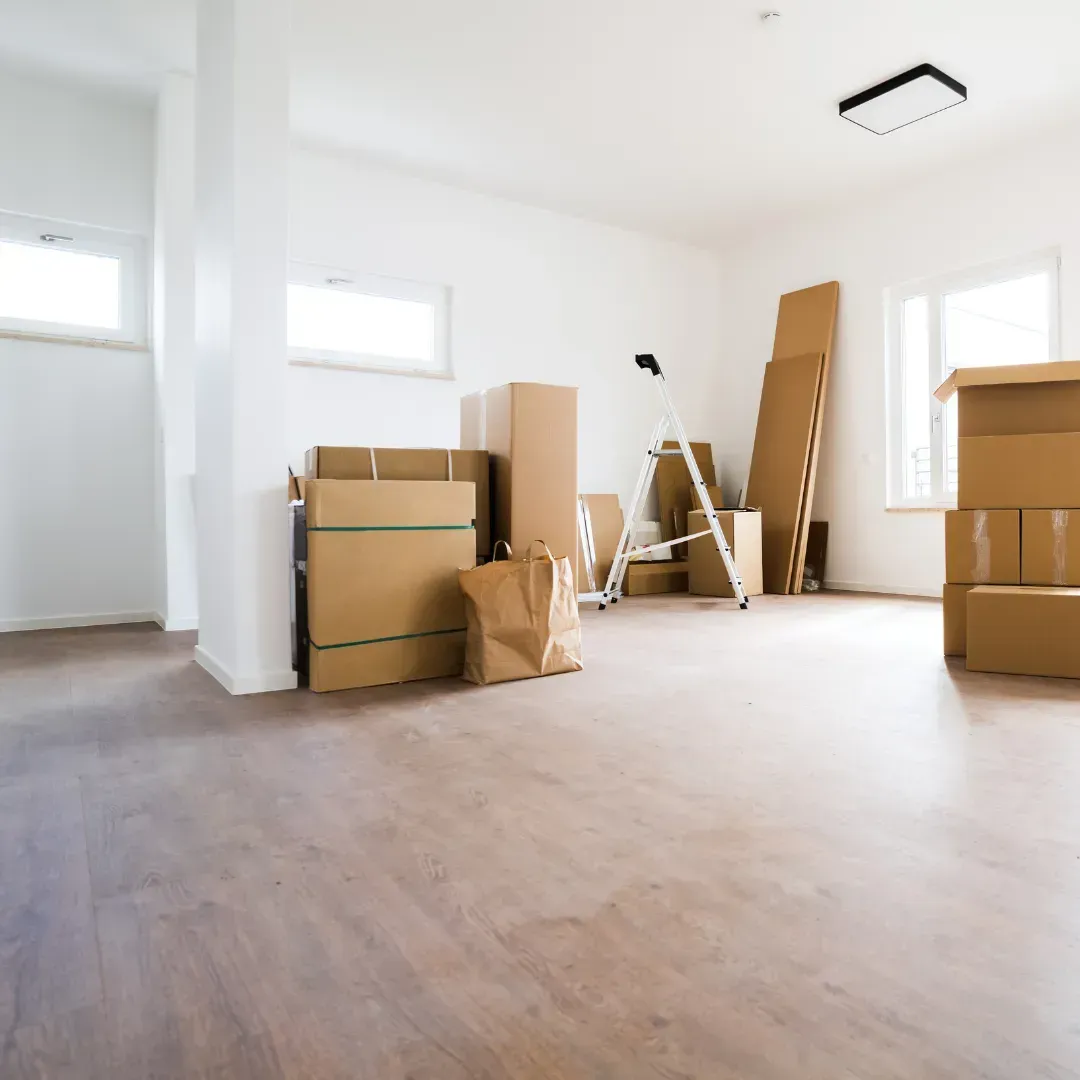 A room with a lot of cardboard boxes on the floor