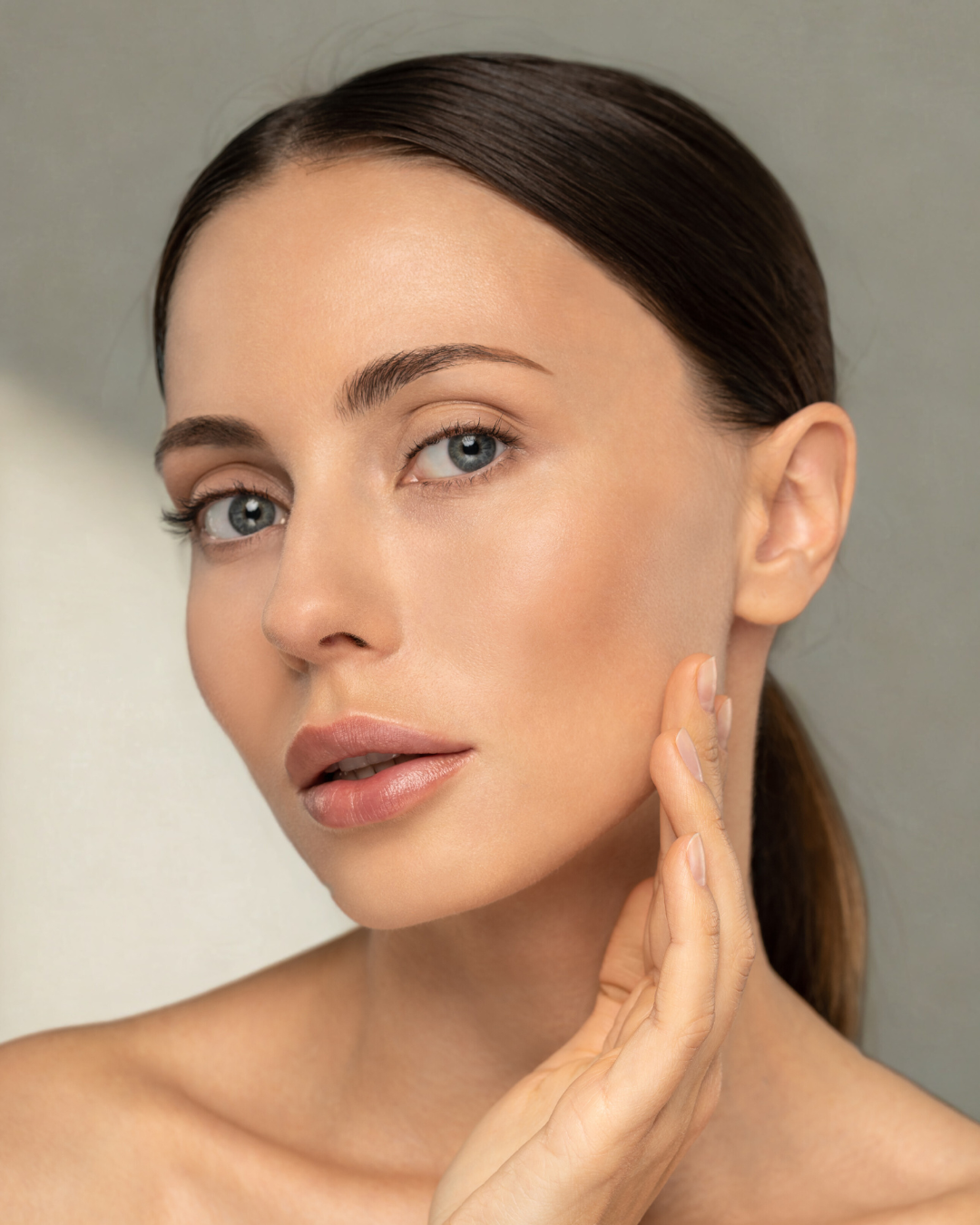 A woman 's face is shown before and after applying makeup.