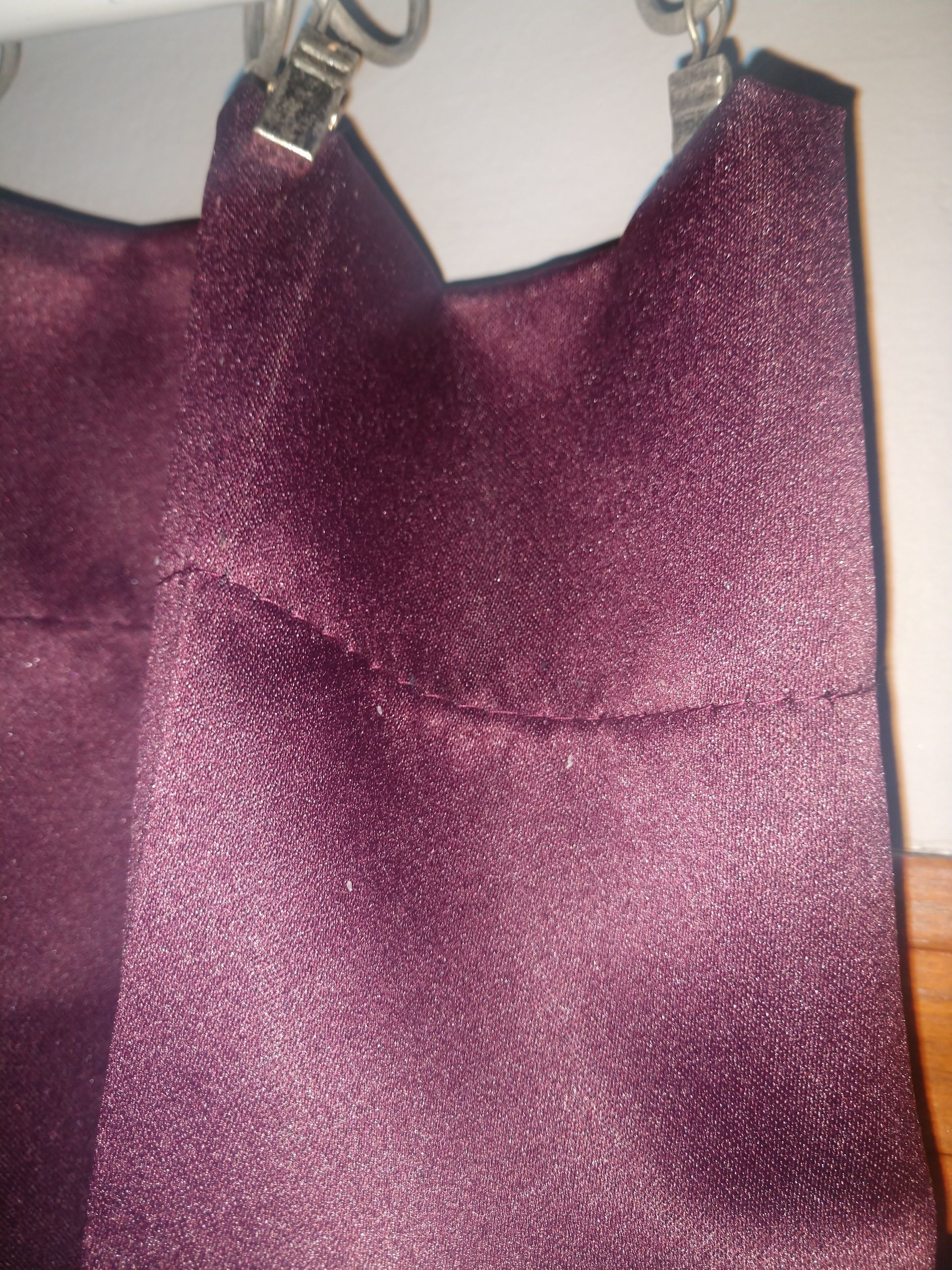 Scattered White Bed Bug Eggs along top folds of curtain