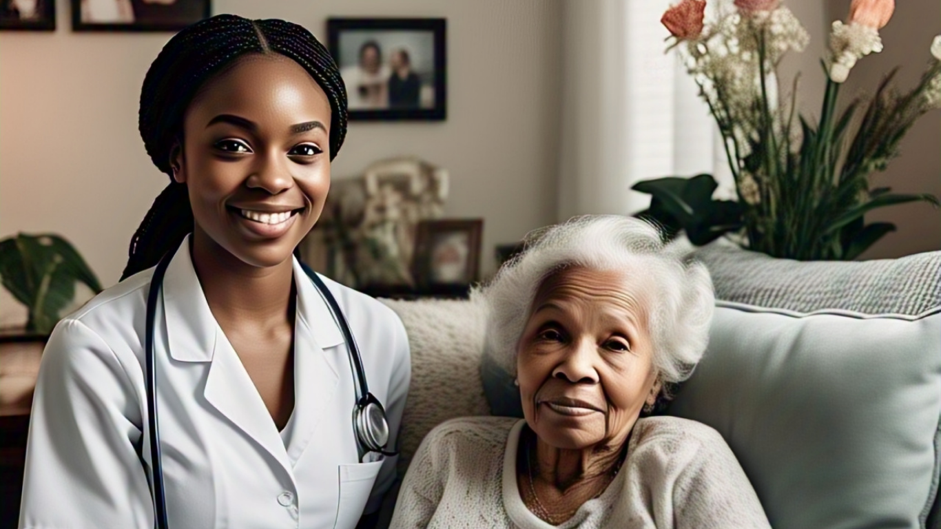 A healthcare worker smiles alongside an older adult on a couch.