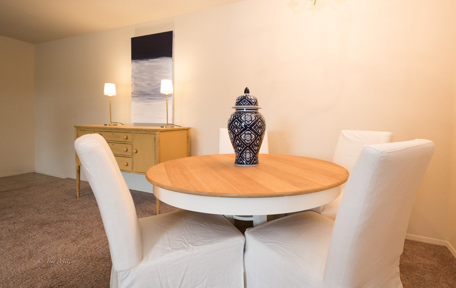 The dining table with blue and white vase on top
