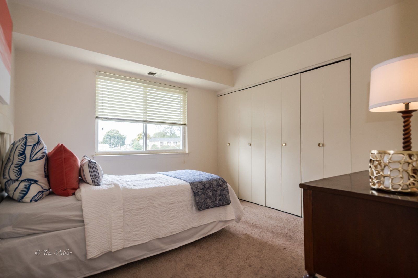 A bedroom with large closet and window