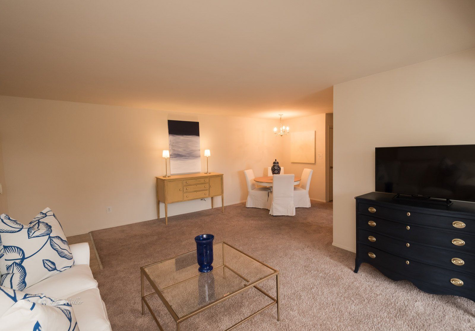 The living room and dining room with a tv