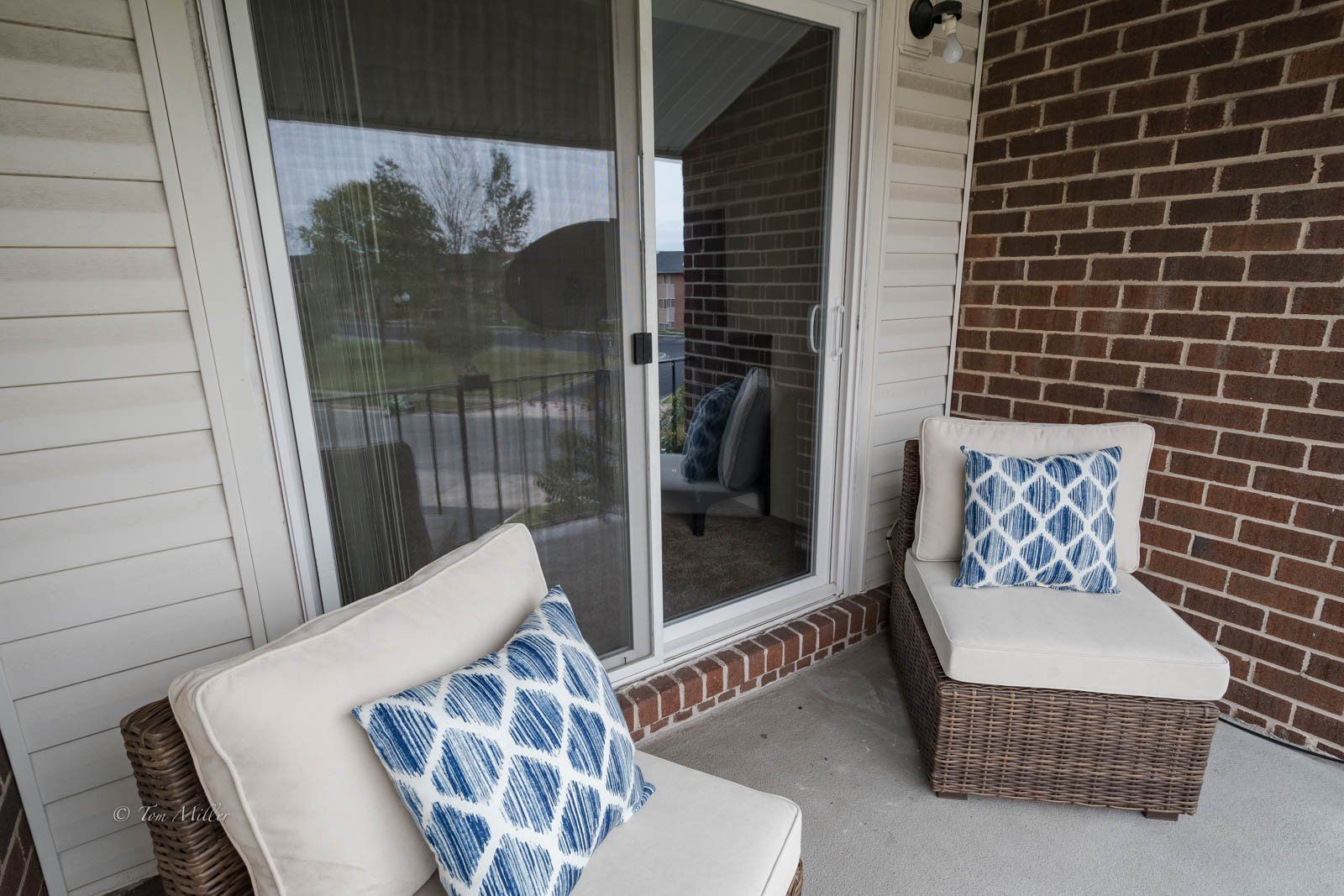 The balcony and patio which has two whicker chairs with cushions