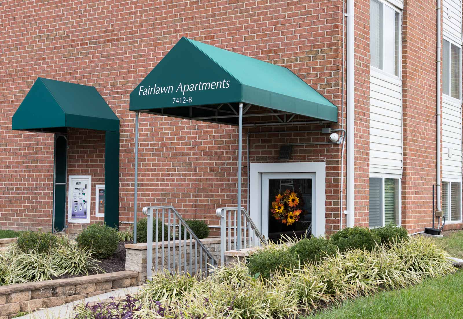 The entryway to Fairlawn Apartments with a fall wreath on the door