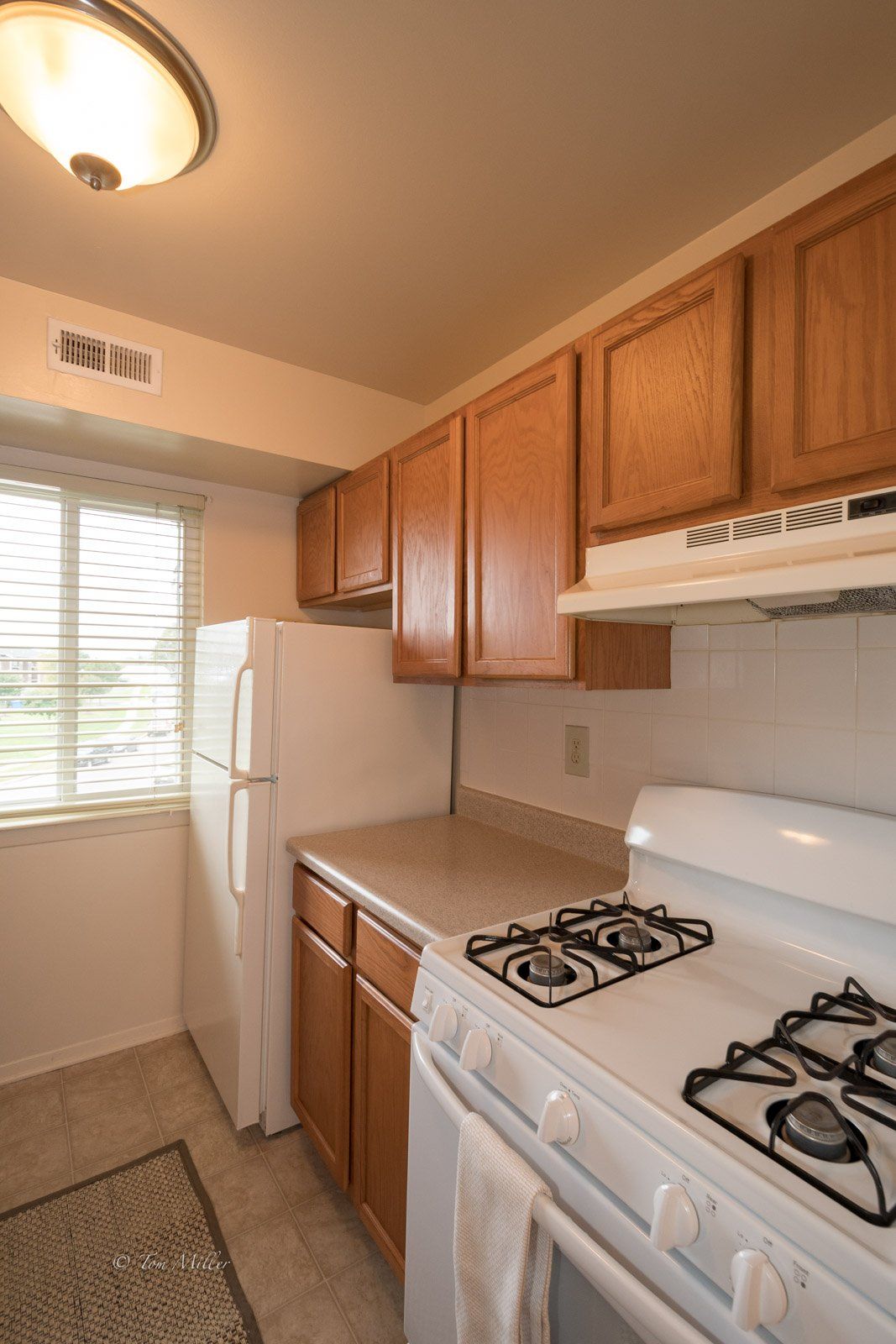 A view of the refrigerator, stove and oven