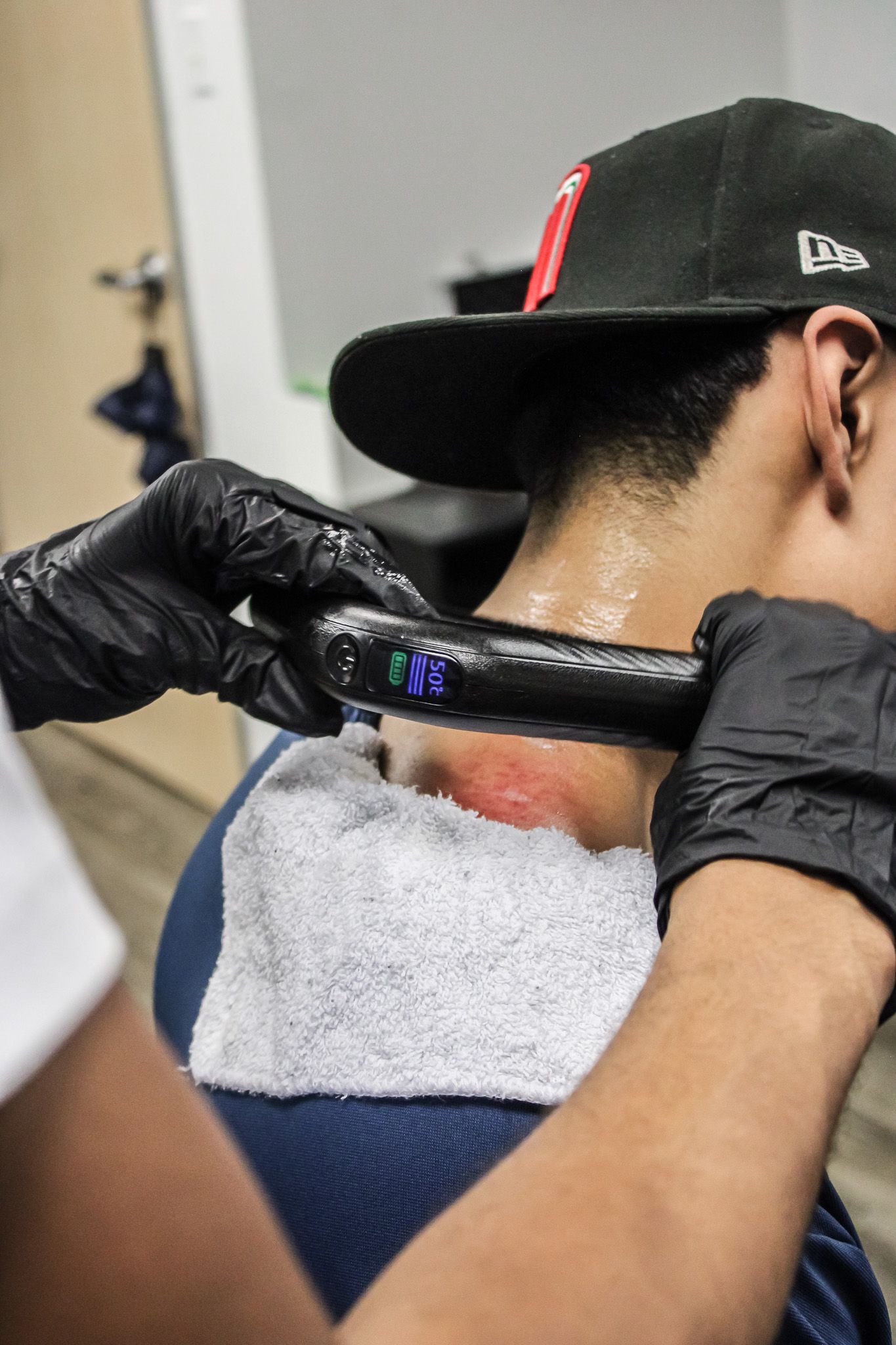 A woman is getting a massage on her back with a spatula.