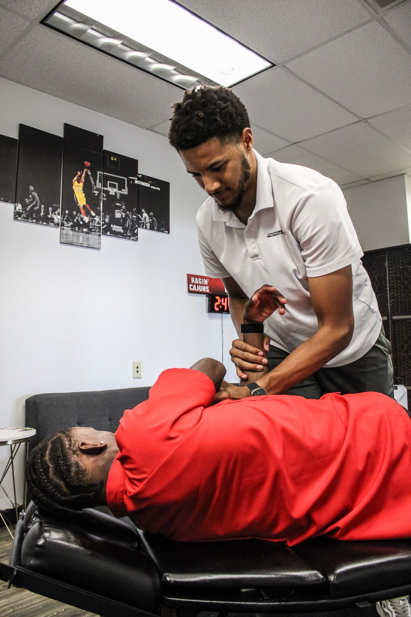 A woman is getting a neck massage from a man.