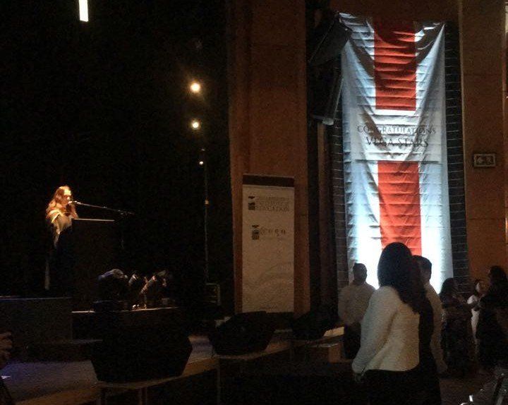 A woman singing into a microphone on a stage