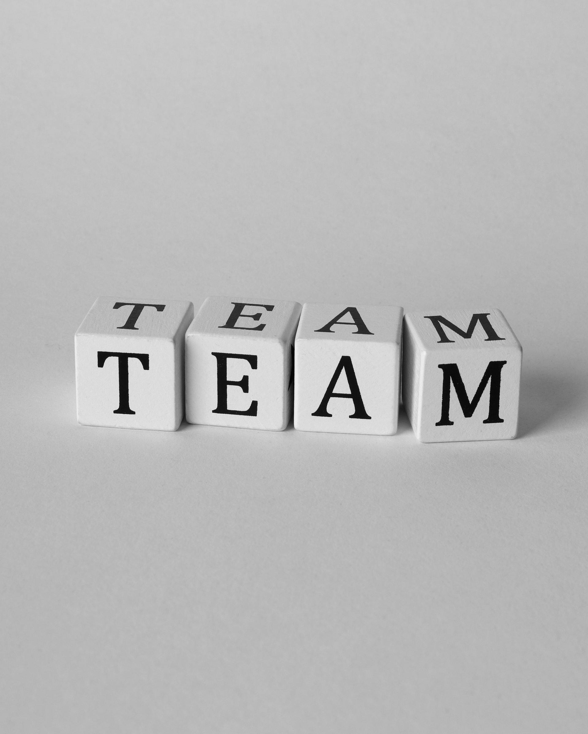 The word team is written on a white block